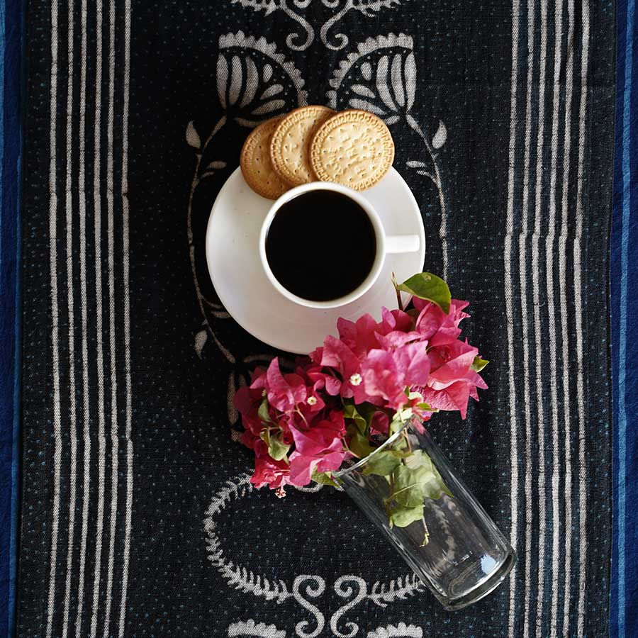 Black and cream hand block printed table runner with floral and striped design.