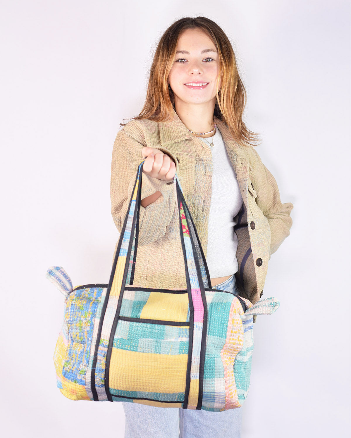 Kid with mini tote bag made from colorful kantha quilts