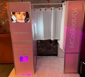 Enclosed photo booth with LED lighting and McOBeauty branding, ideal for beauty brand activations and high-end marketing events.