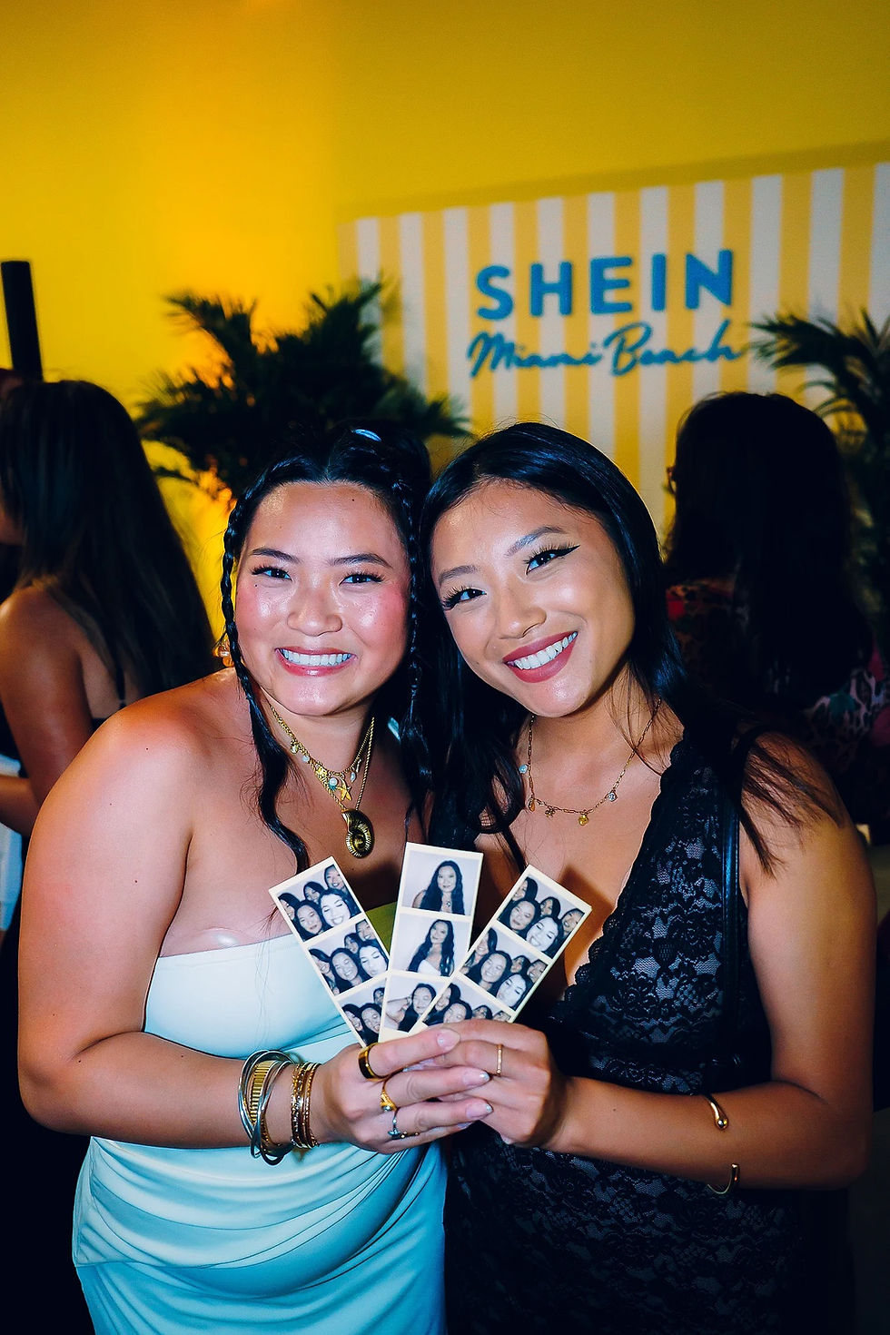 Close-up of SHEIN enclosed photo booth exterior during Miami event, showing detailed panel wrap and vibrant event atmosphere.