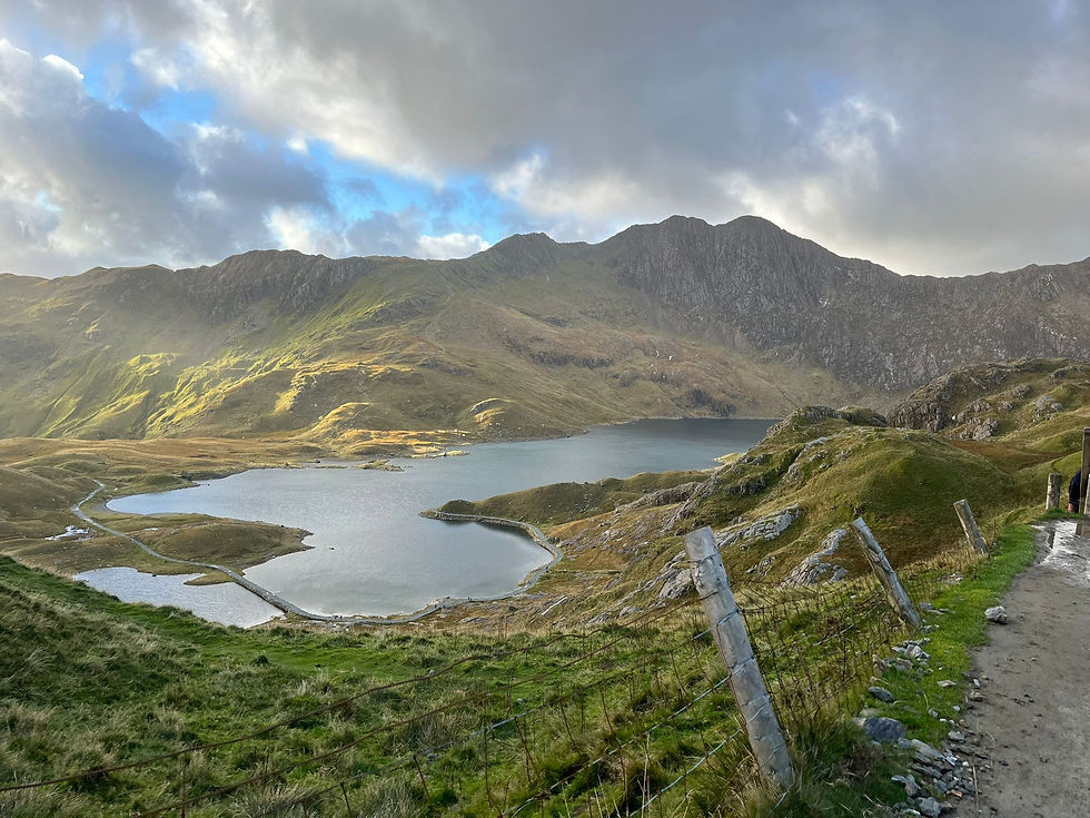 The sun breaks through the clouds on Snowdon.