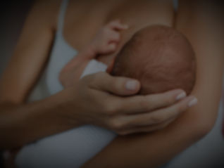 A mother breastfeeding a newborn baby