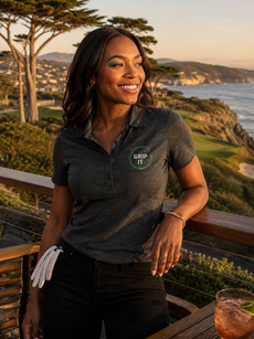 Woman smiles at ocean golf course view at sunset