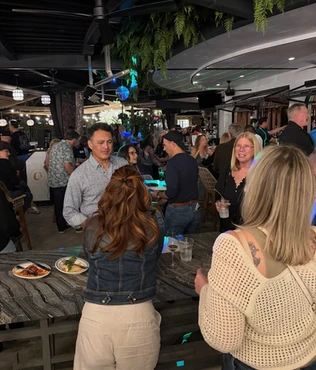 Guests talking and laughing at Kindred’s social mixer.