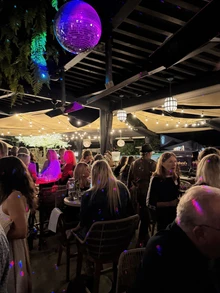 People at Kindred’s Social Mixer under a disco ball.