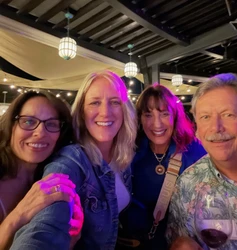 Four people smiling at Kindred’s Social Mixer.