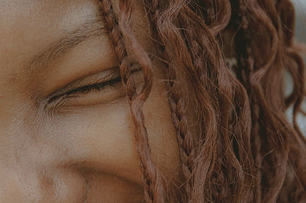 Close-up of a smiling woman with braided hair._edited.jpg