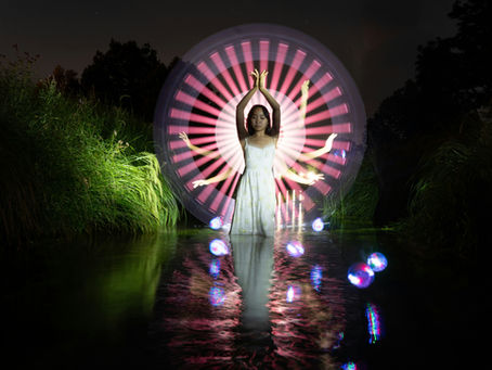 Woman with multiple arms, psychedelic image with dark background and lights