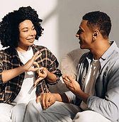 Two adults doing sign language