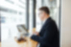 Man near a window using his laptop at a desk