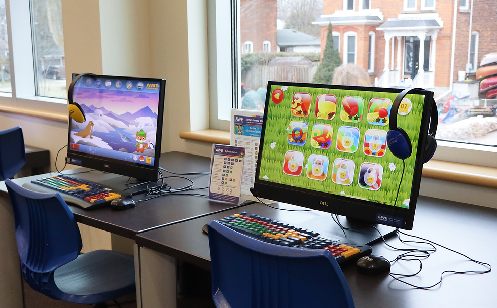 Two computer stations in front of a window. The screens are displaying games.