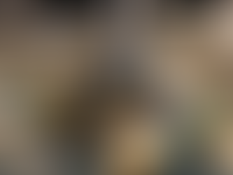 A large woolly mammoth skeleton display inside the Prehistoric Museum in Utah, viewed from above, surrounded by Native American artifacts, pottery exhibits, a replica teepee, and a mural depicting Ice Age animals.