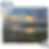 Nearly completed jigsaw puzzle of a peaceful lakeside sunset scene, with unassembled pieces scattered in the top left and bot
