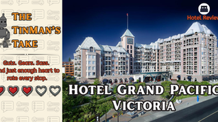 Graphic hotel review for the Hotel Grand Pacific in Victoria. On the left, a section labeled “The TinMan’s Take” shows a cartoon tinman and the tagline: “Guts. Gears. Sass. And just enough heart to rate every stop.” The hotel receives a 3 out of 5 heart rating, with three red hearts and two gray ones. On the right is a large photo of the grand hotel with Victorian-style architecture, and bold text that reads “Hotel Grand Pacific Victoria.” A suitcase icon in the top-right corner indicates this is a hotel review.