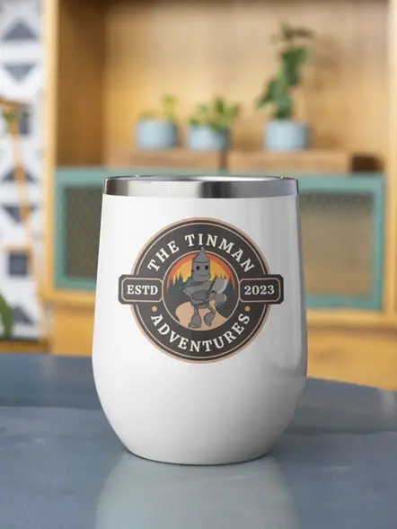 A white wine tumbler sitting on a grey table top.