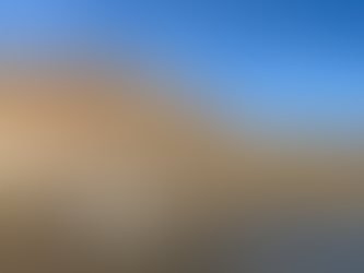 The Dolly Steamboat cruising across Canyon Lake with tall, rugged desert cliffs rising behind it under a bright blue sky.