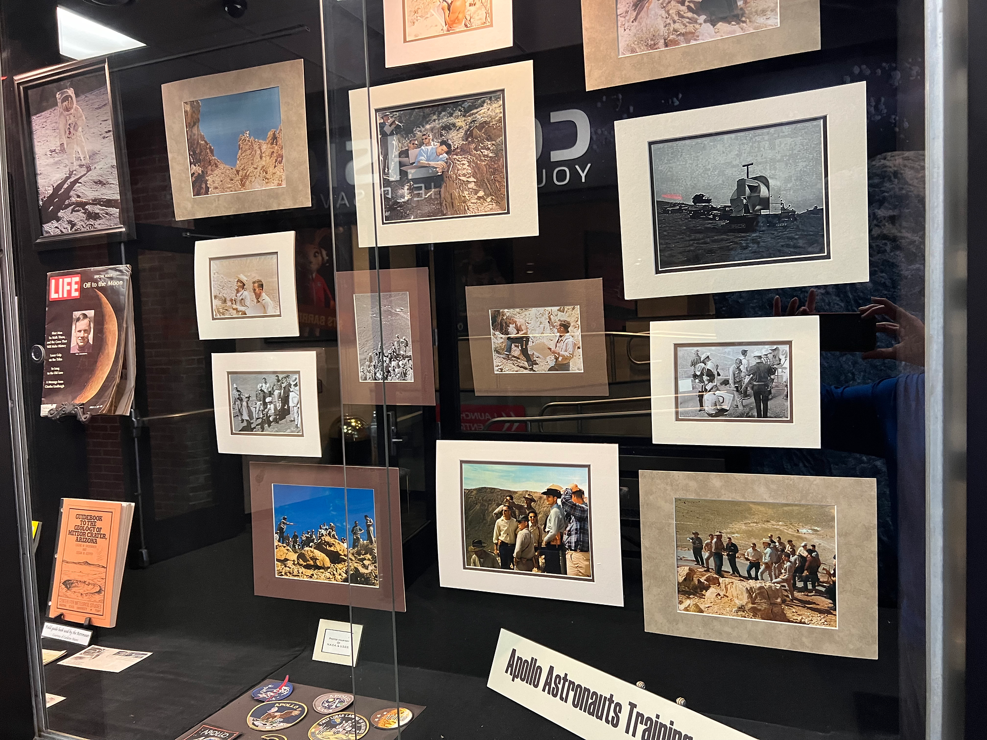 A display case full of pictures of Apollo Astronauts Training.