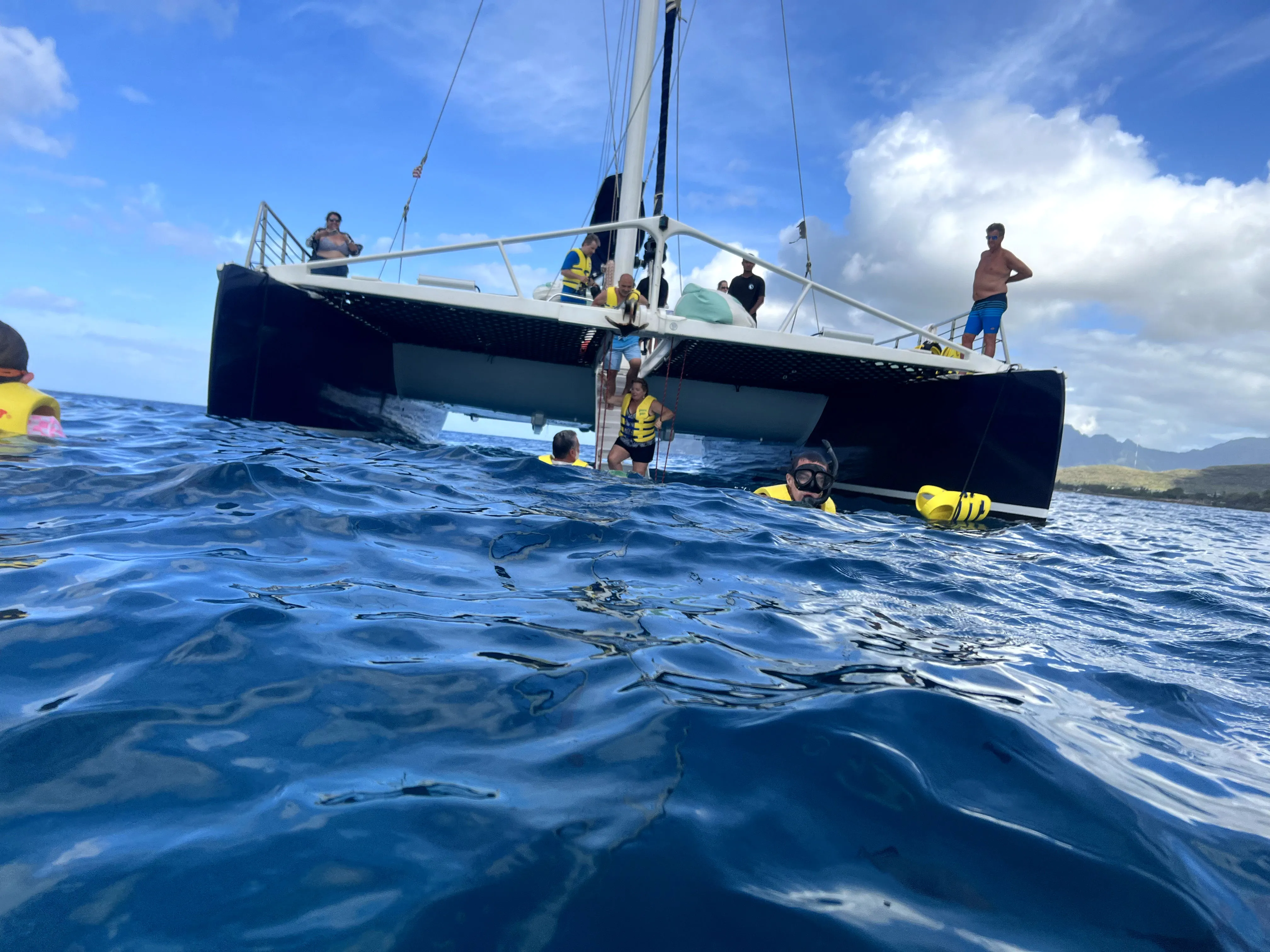 In ocean, view of boat in water, snorkeling in Hawaii, Ko Olina Ocean Adventures.