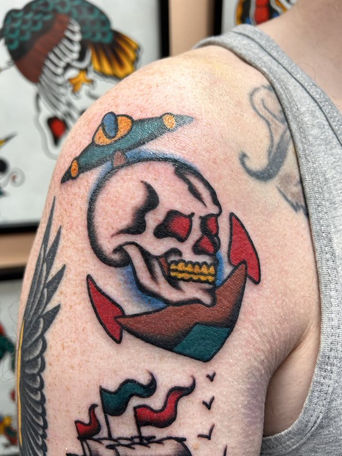 Traditional skull tattoo with fierce eyes and bold red background