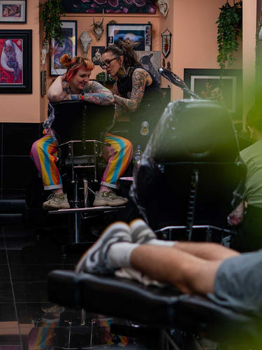 several customers getting tattoos in the studio
