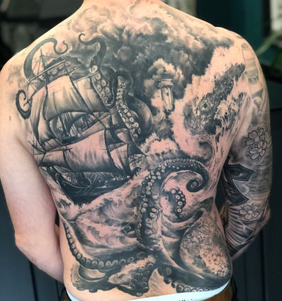 Realism tattoo of a ship in a battle with a kraken on the back of a man