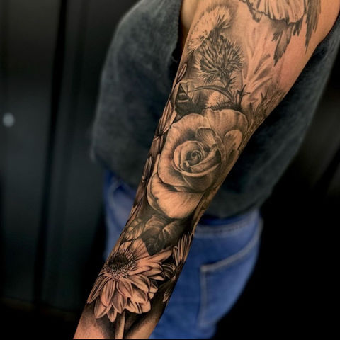 Black and grey realism tattoo on an arm