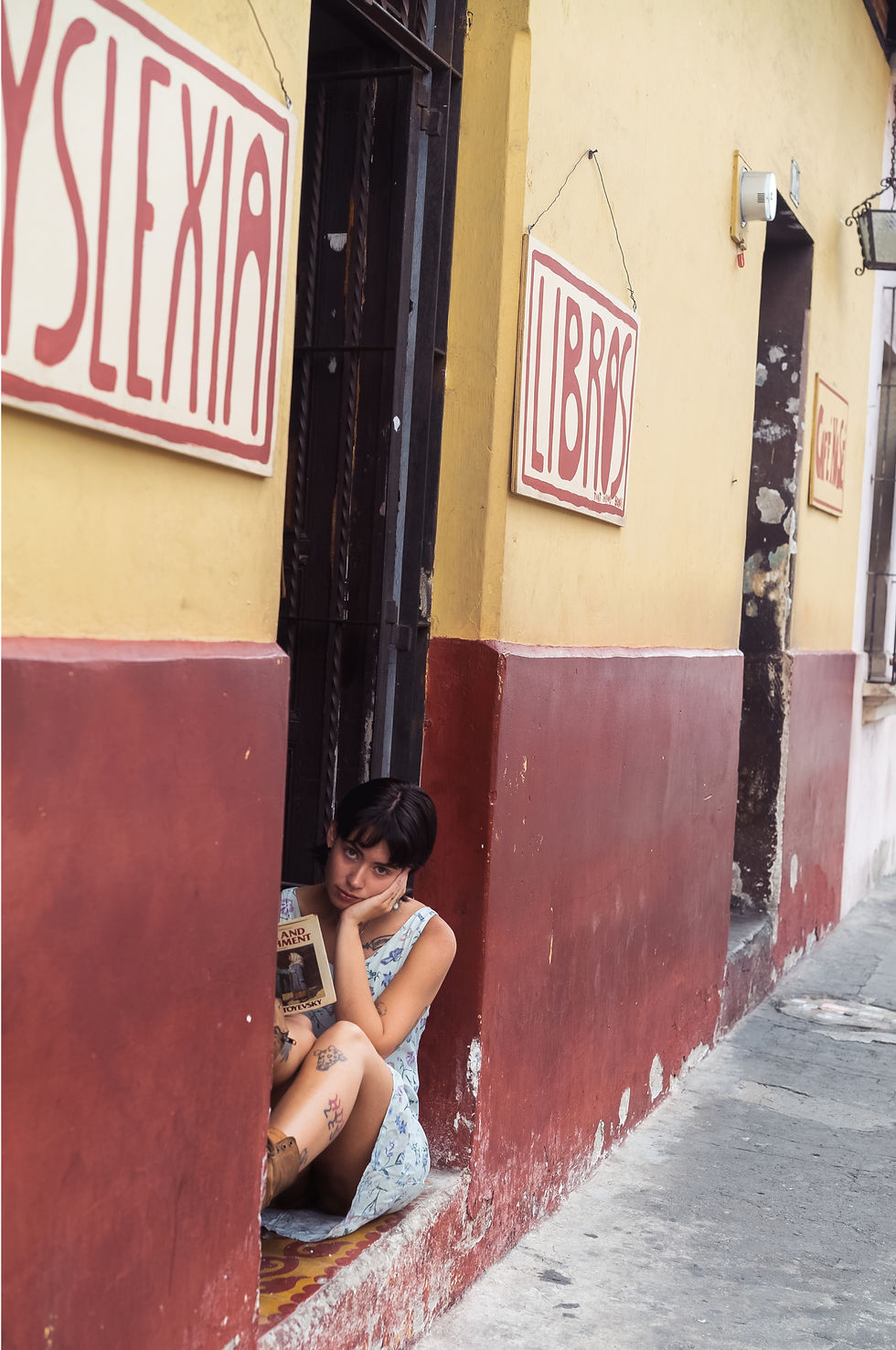A beautiful girl reading Crime and Punishment outside of a bookstore