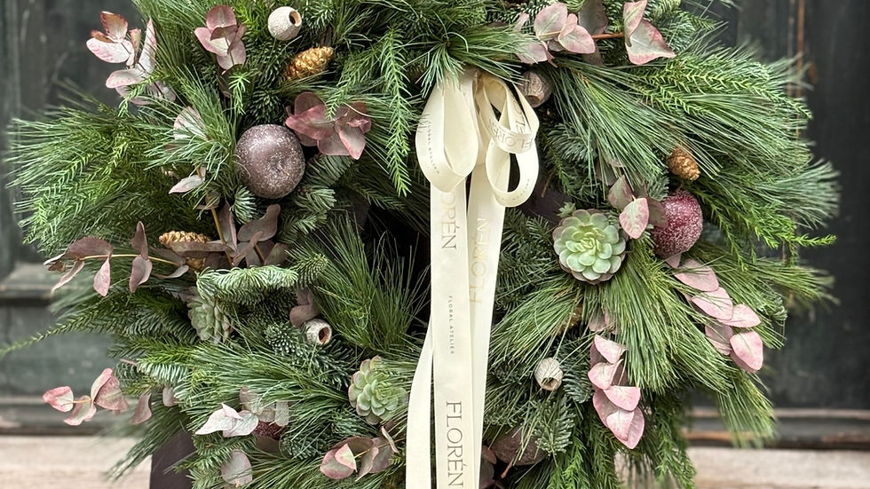 Eye-level view of handmade Christmas wreath with eucalyptus and pine cones