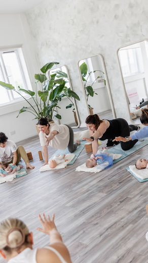 women practicing pilates with their babies