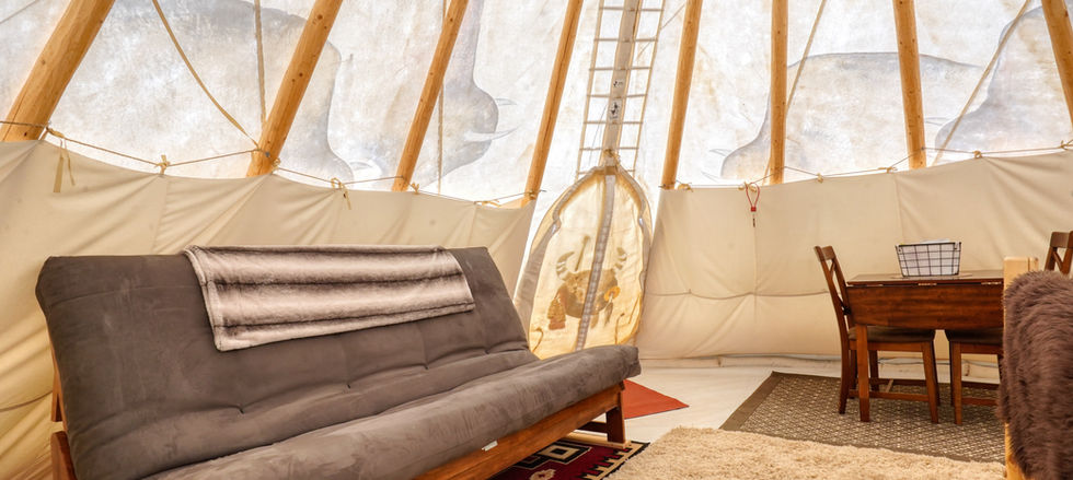 Futon in Buffalo Tipi at Highland Meadows Resort. Bison art can be seen through the canvas. Tipi by Nomadics tipi makers.