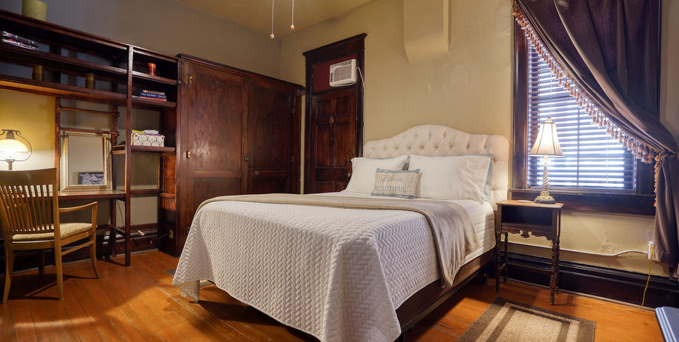 Queen bed in historic FlatIron Inn - Hot Springs, South Dakota