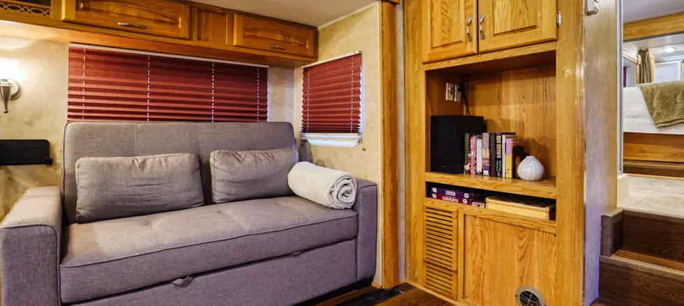 Couch, books, and games in renovated RV.