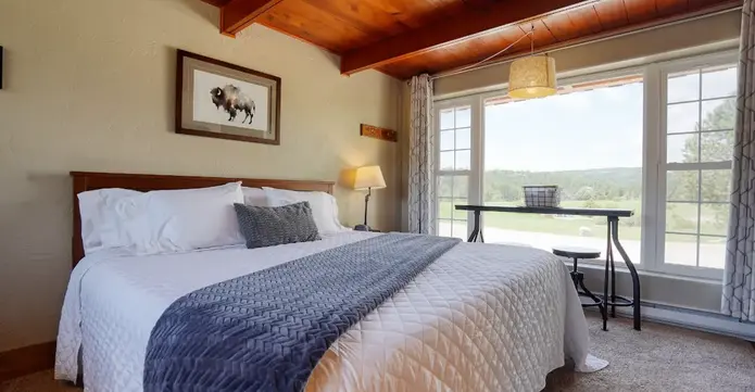 Bison watercolor print above king bed in rental cabin in Hot Springs, SD