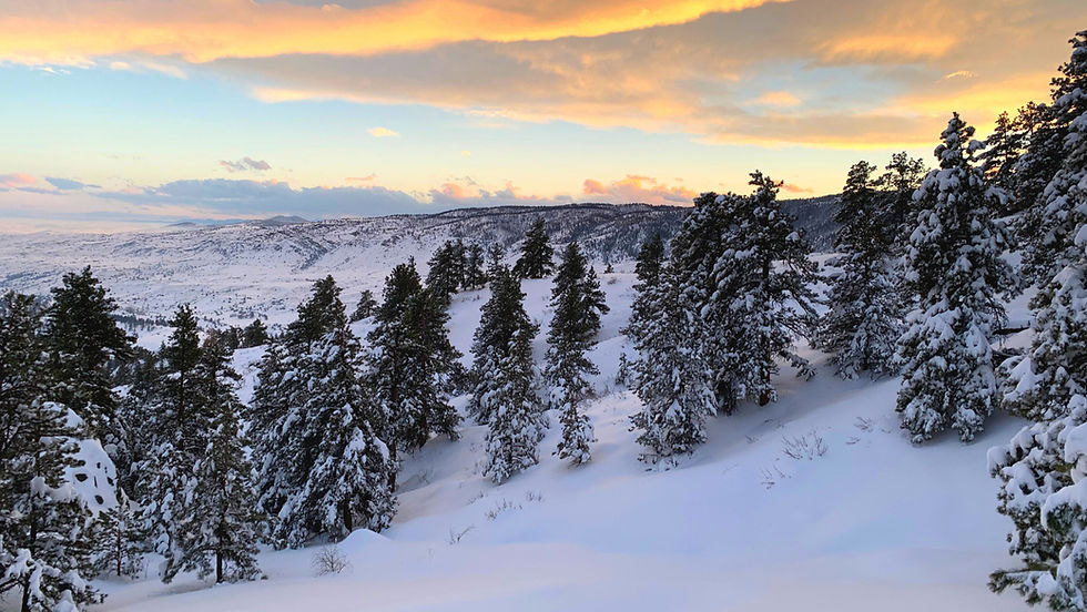 Sun setting over a snowy mountain while we were snowed in