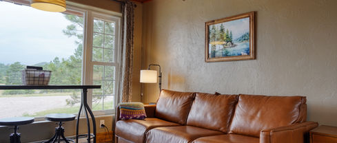 Leather couch and art print of Sylvan Lake in Custer State Park.
