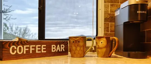 Coffee bar inside RV rental at Highland Meadows Resort. Keurig & Owl mugs.