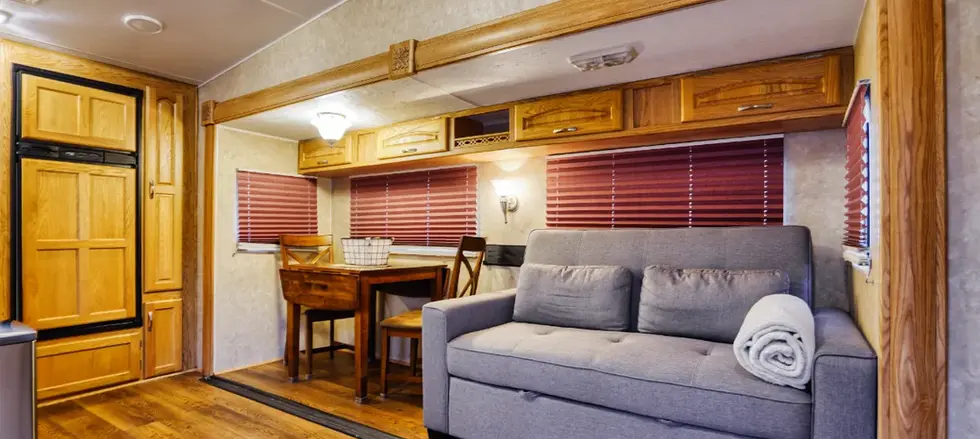 Couch, table, and chairs inside RV for rent in Hot Springs, South Dakota.