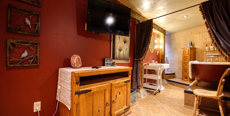 Bathroom w/ clawfoot tub and drapes for doors in the FlatIron Historic Hotel.
