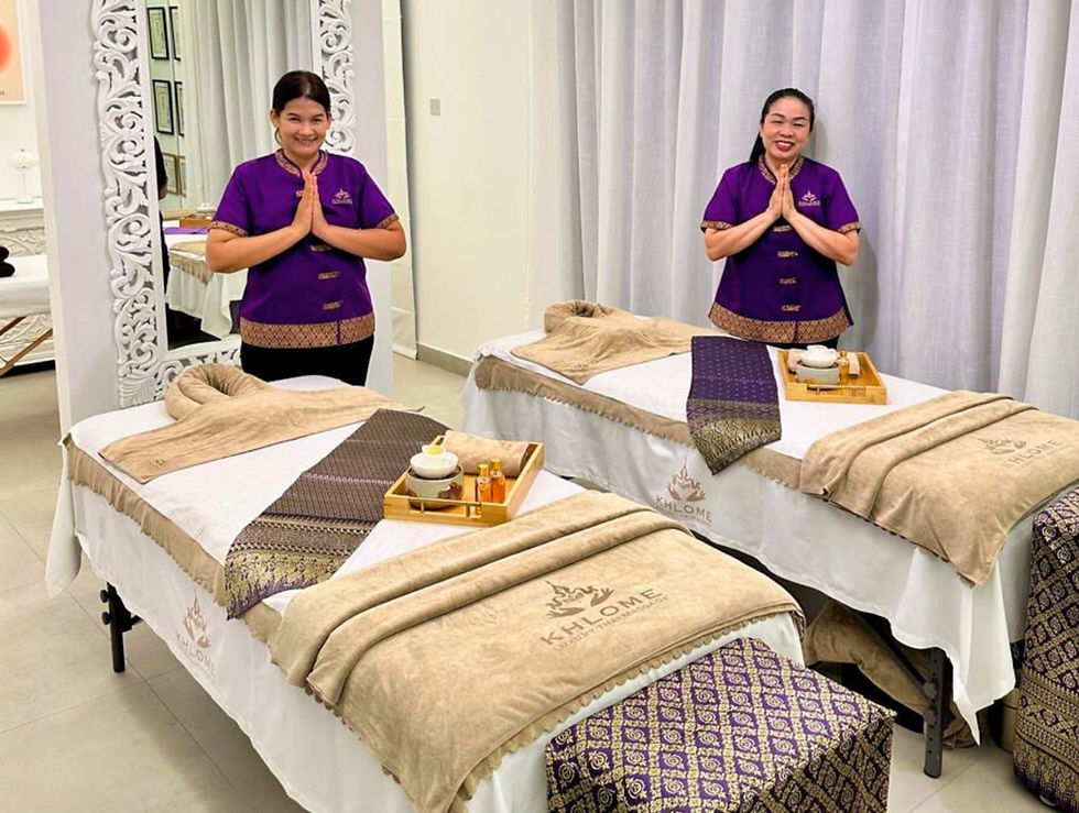 Two Khlome Thai massage beds prepared side by side at home with female therapists ready for a couple massage session in Dubai.