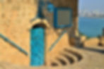 Ancient Jaffa stone building with blue door.