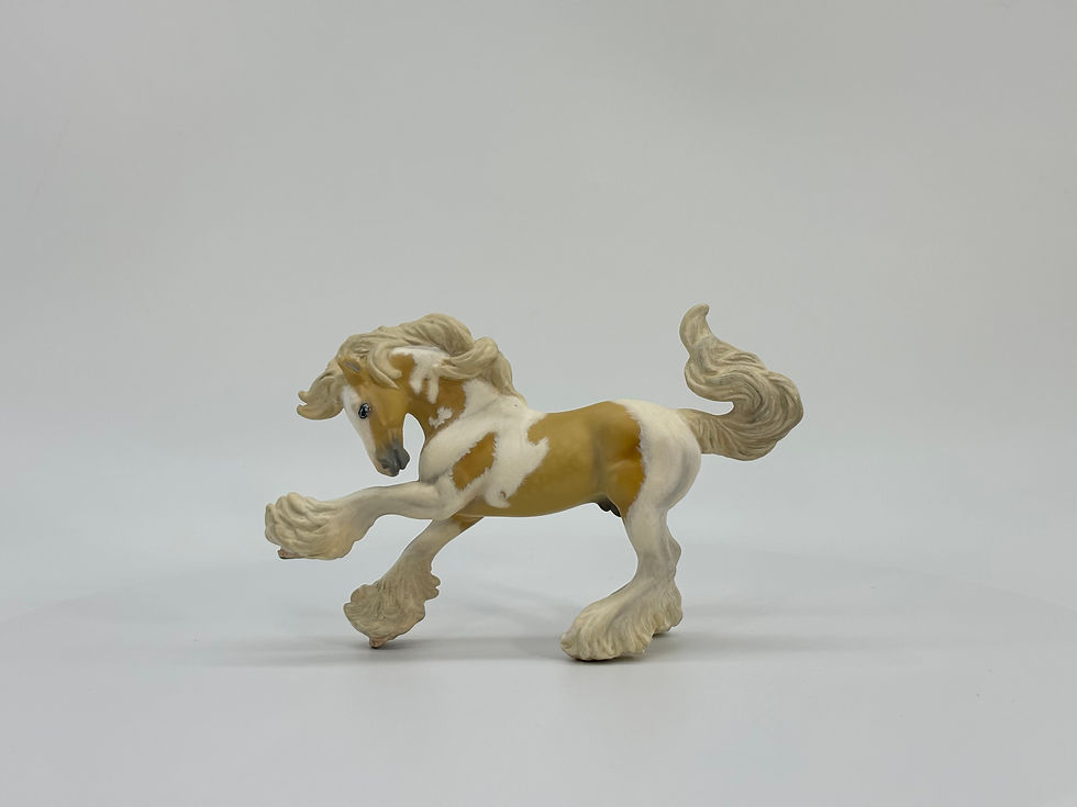 Breyer custom Stablemate painted to a palomino pinto at a side view