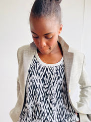 Woman in a tank top with print and a jacket