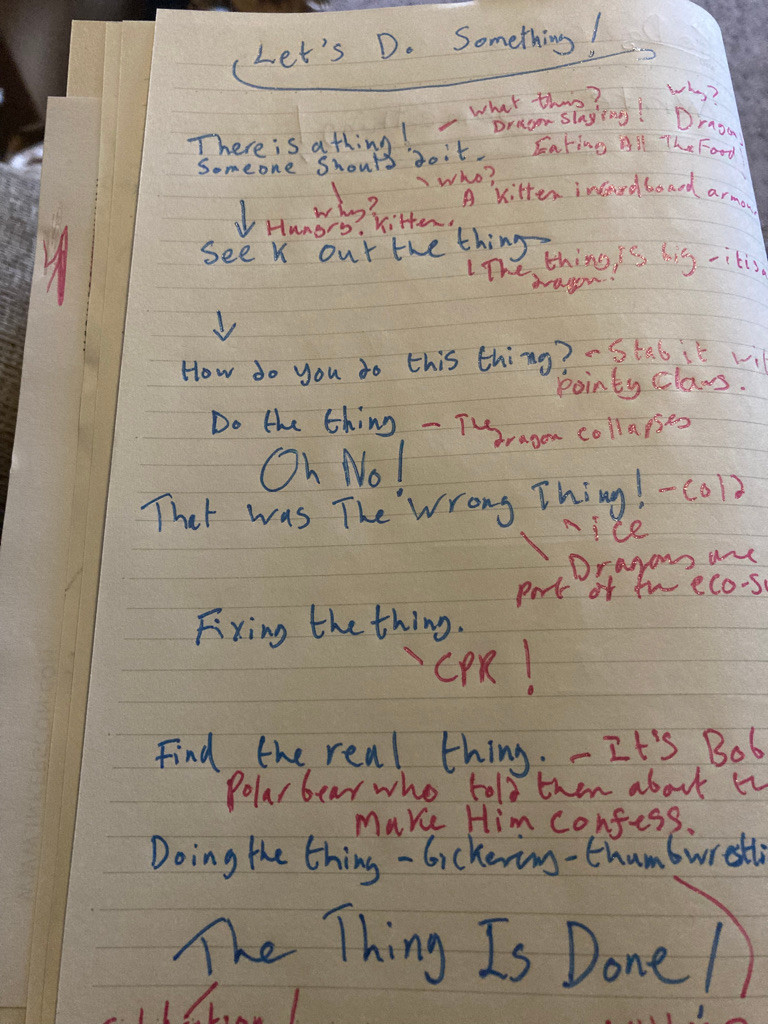 A page of lined paper without margins. A rough plan is scribbled on it in sparkly blue pen, with notes in even scribblier sparkly pink. Most of the text is illegible, but clearly visible are the sentences "Let's Do Something!" at the top; "Oh No! That was the wrong Thing!" halfway down the page, and; "The Thing is done!" at the bottom.