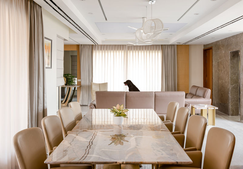 Automated Living room with premium sofa and marble finish dining table