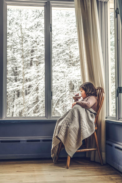Child in chair gazing outside into the abyss during Children Photography Session with Chumie Paneth Photography