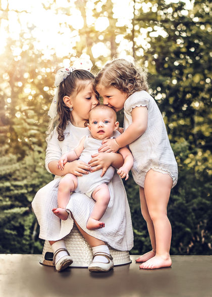 Siblings holding newborn during Family Photography Session with Chumie Paneth Photography