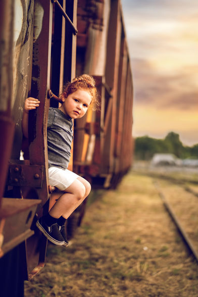 Little boy sitting on a train car during Upsherin Photography Session with Chumie Paneth Photography