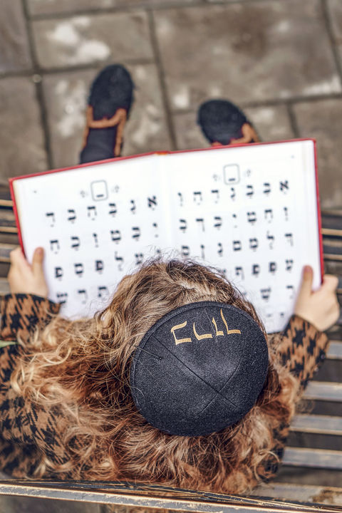 Little boy reading Hebrew during Upsherin Photo Session with Chumie Paneth Photography