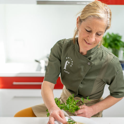 Anita garnishing her dish