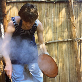 Anita outside in Congo cooking over open fire